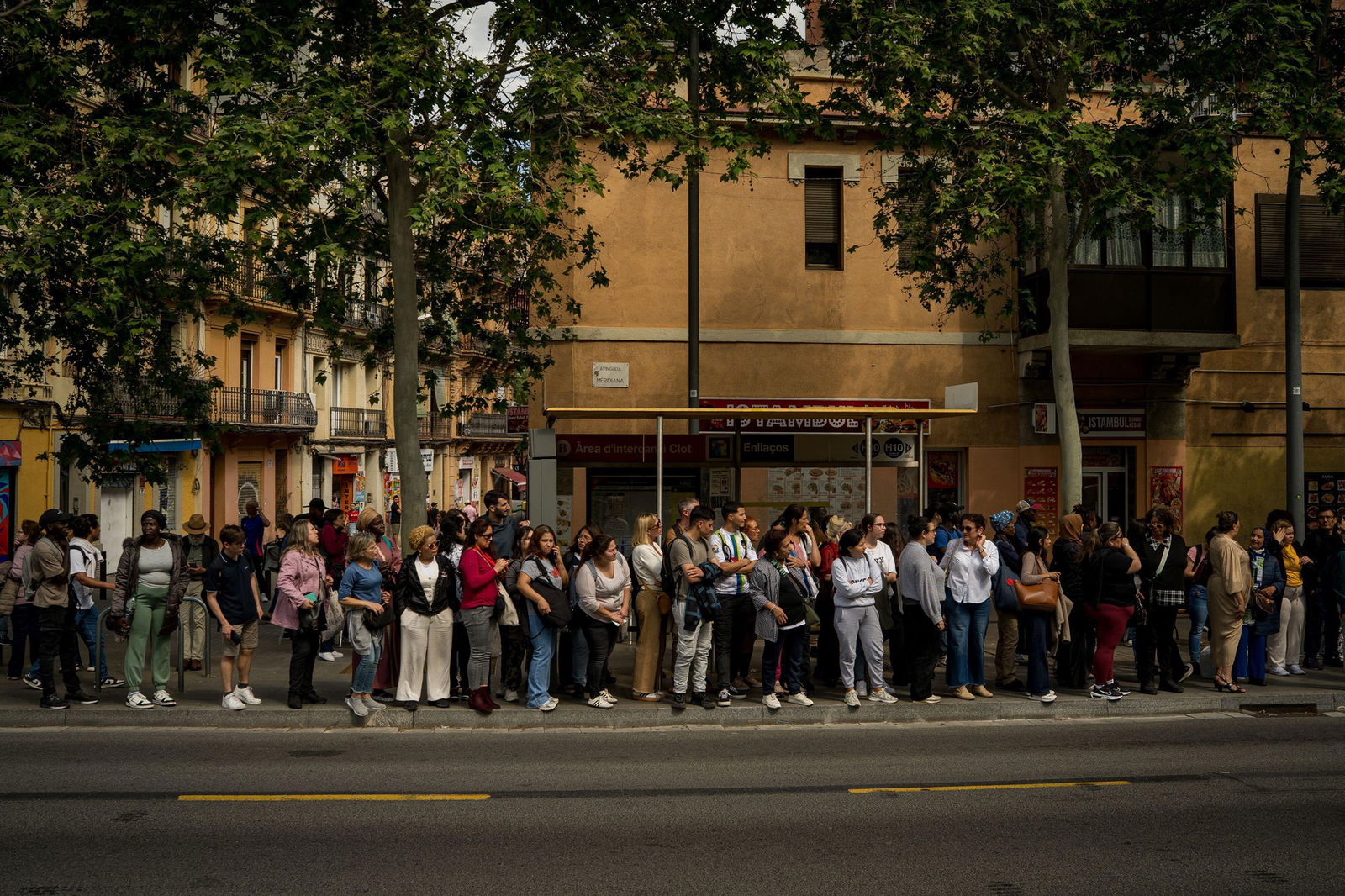 People are seen waiting for the bus as the subway remains closed due to the power outage. 