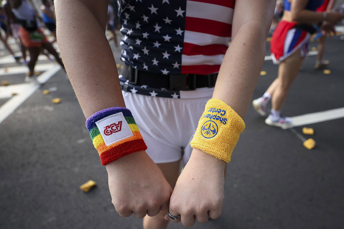 A runner shows off his arm bands along Hope Hill during the 57th running of the Peachtree Road Race on Saturday in Atlanta. 