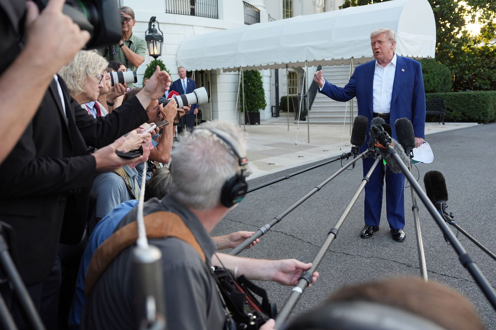 President Donald Trump speaks with reporters before boarding Marine One on the South Lawn of the White House.