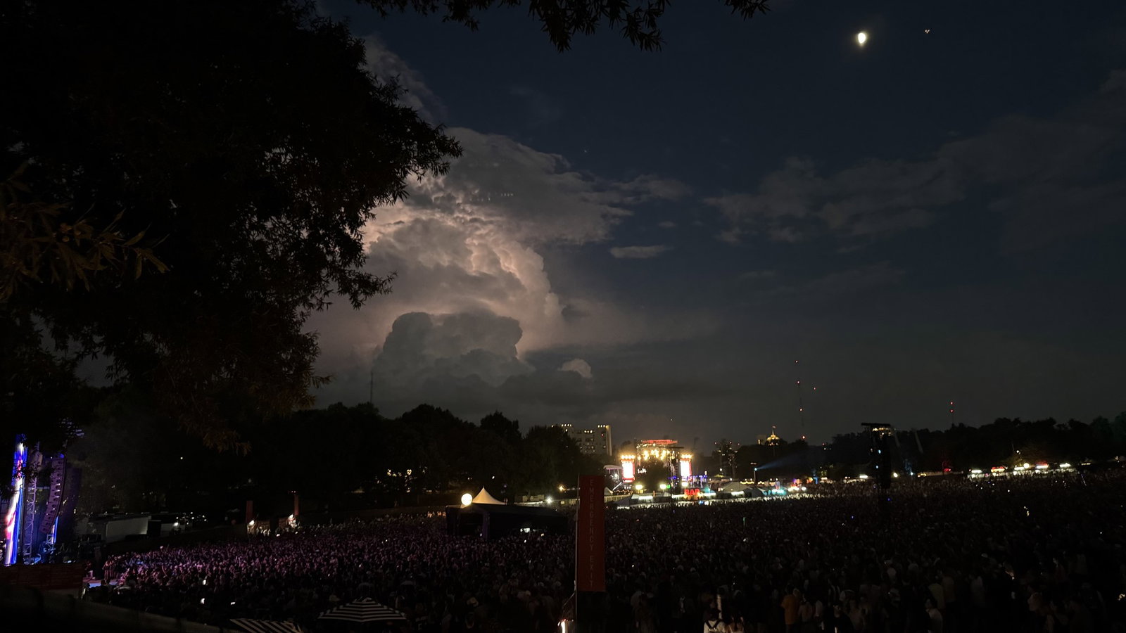 Lightning is seen in the distance during LCD Soundsystem’s Sunday set.