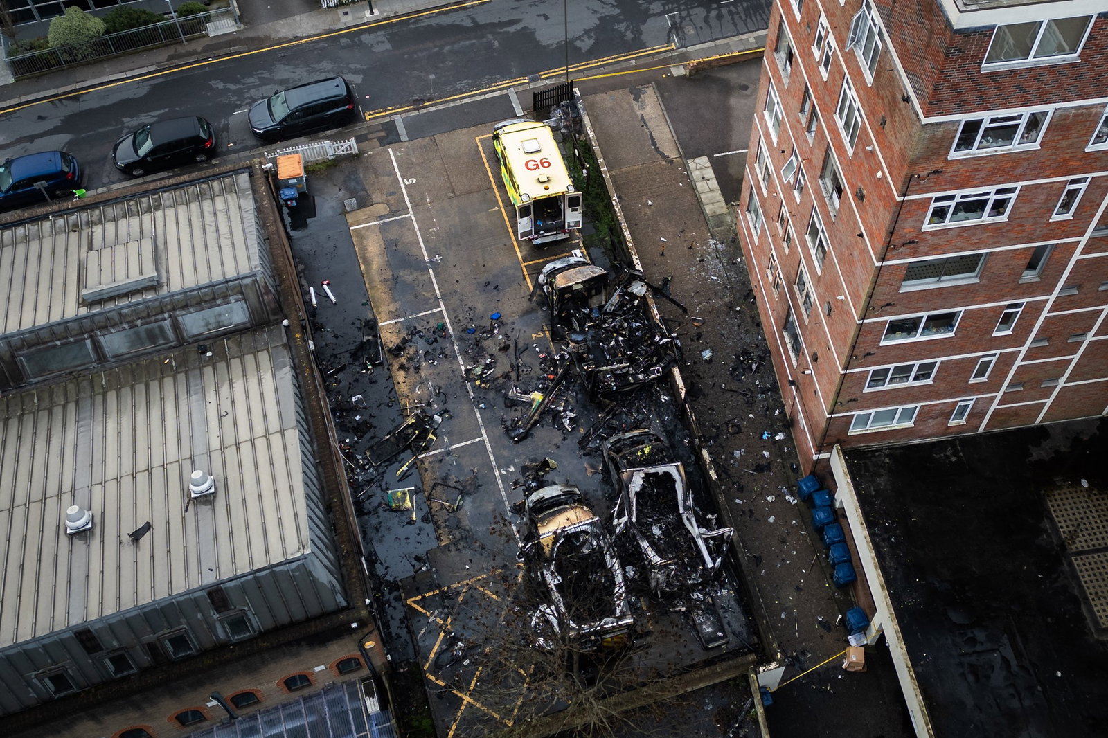 Police are hunting three men who torched the ambulances