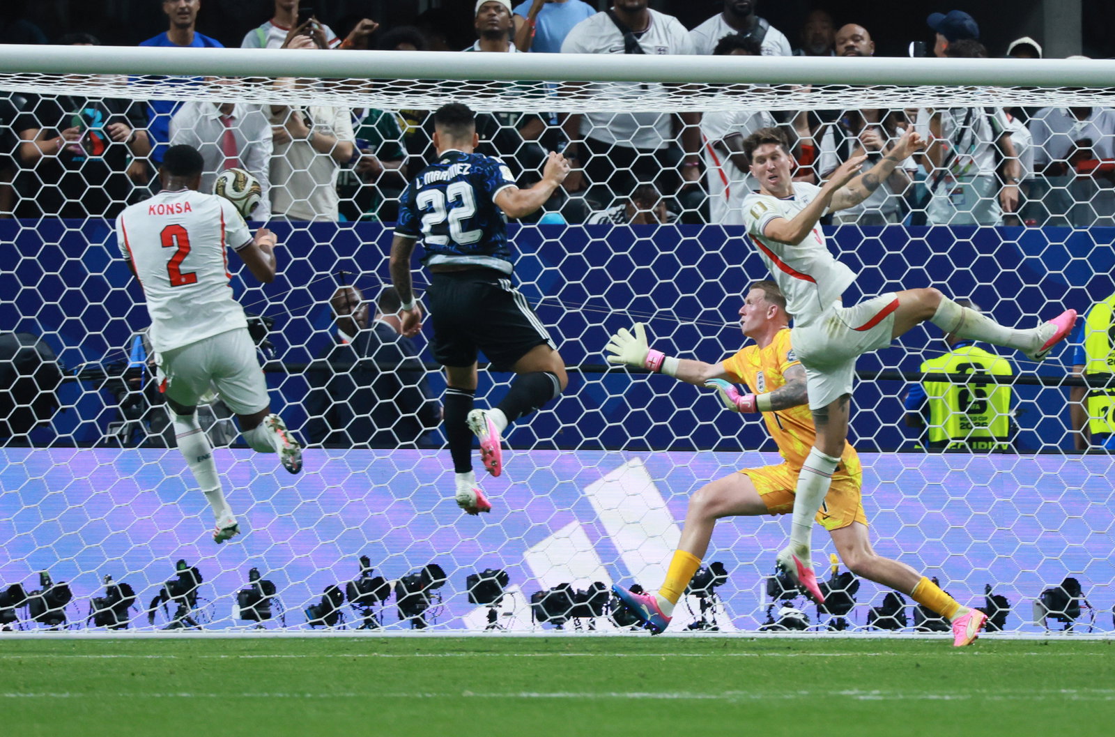 Argentina's Lautaro Martinez (center left) heads the ball past England goalkeeper Jordan Pickford (center right, in yellow) for the winning goal during the second half of their FIFA World Cup semifinal match at Atlanta Stadium on Wednesday, July 15, 2026.
