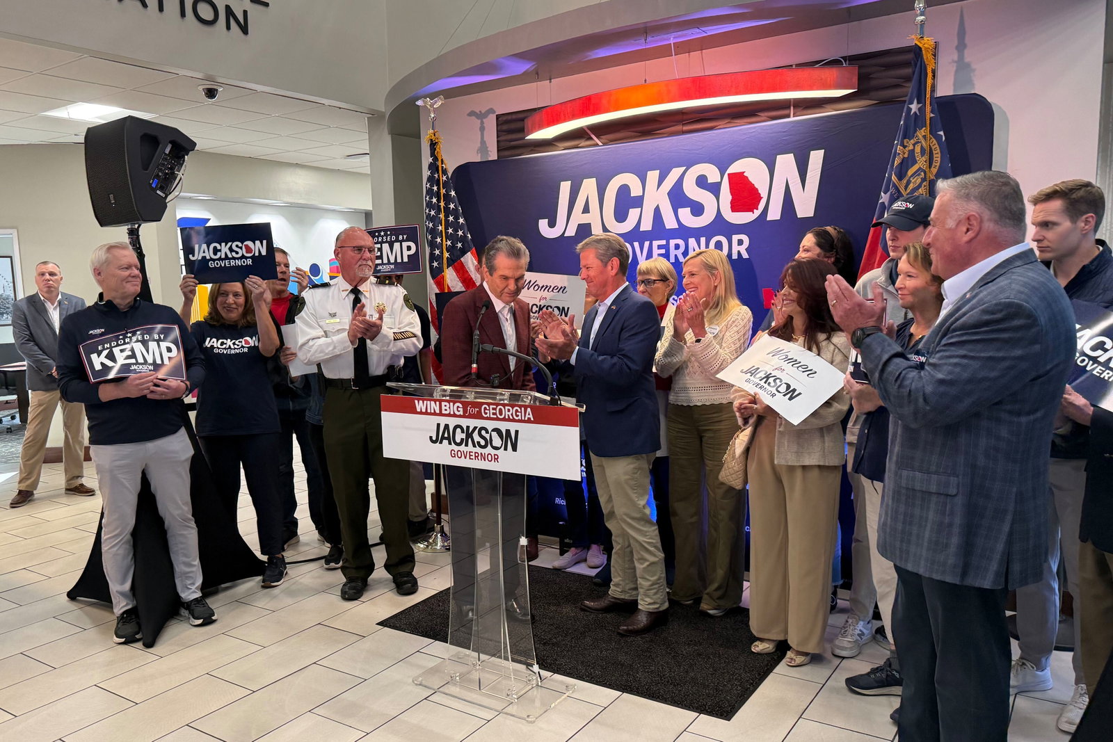 Gov. Brian Kemp (right) and Republican nominee Rick Jackson kick off a daylong fly-a-round tour at Signature Aviation in Atlanta Monday.