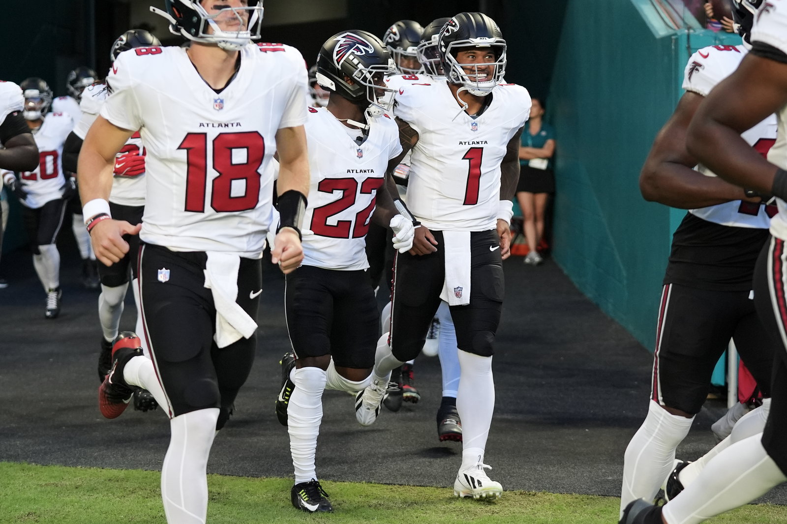 Falcons quarterback Jack Strand (from left), defensive back Clark Phillips III and quarterback Tua Tagovailoa jog onto the field before an NFL exhibition game against the Dolphins on Friday, Aug. 28, 2026, in Miami Gardens, Fla.