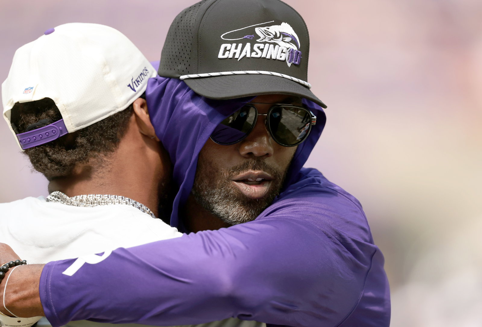 Minnesota Vikings legend Randy Moss hugs a player on the sidelines before today's NFL preseason game against the Baltimore Ravens.