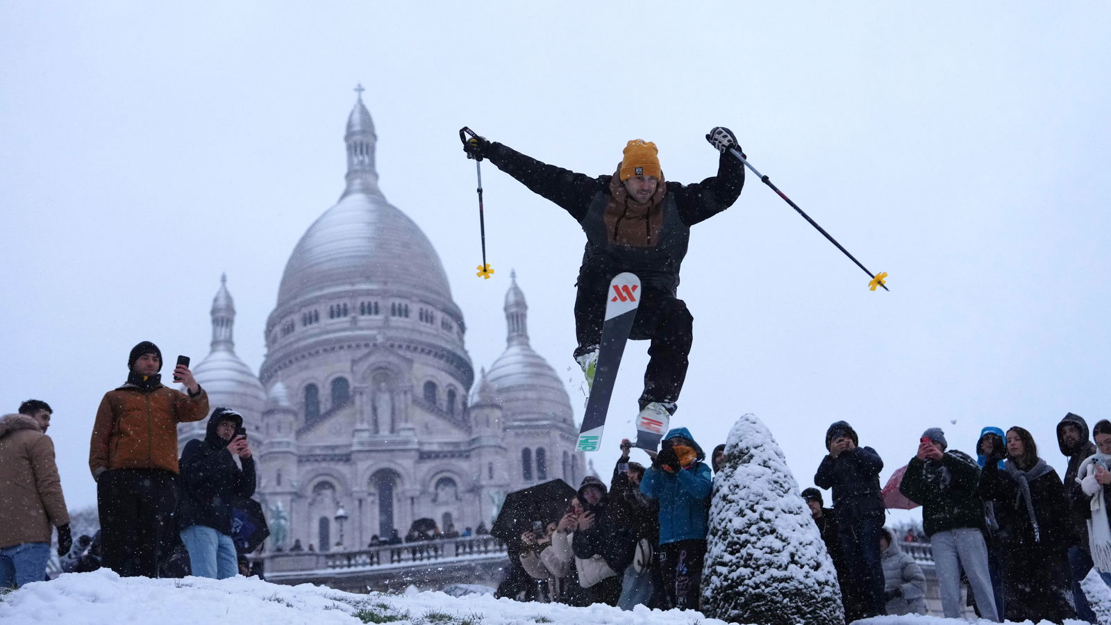 A man skies down the hill by the Sacre-Coeur basilica during a snowfall in the Montmartre district of Paris, France